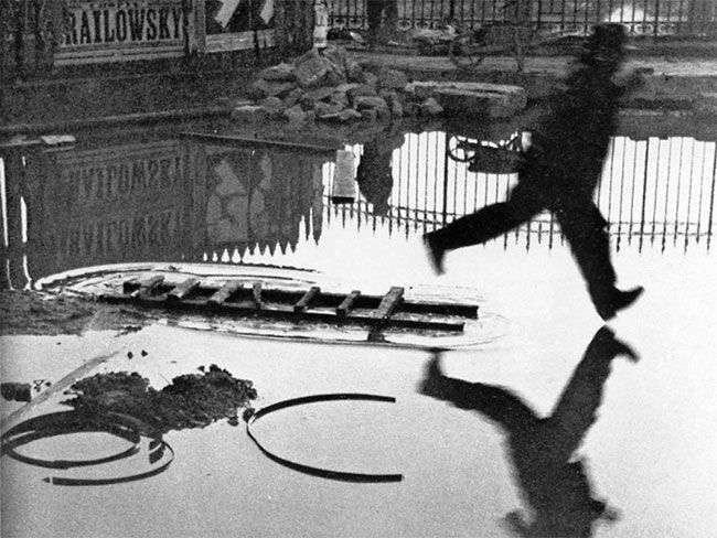 Man Jumping the Puddle by Henri Cartier-Bresson (1930)