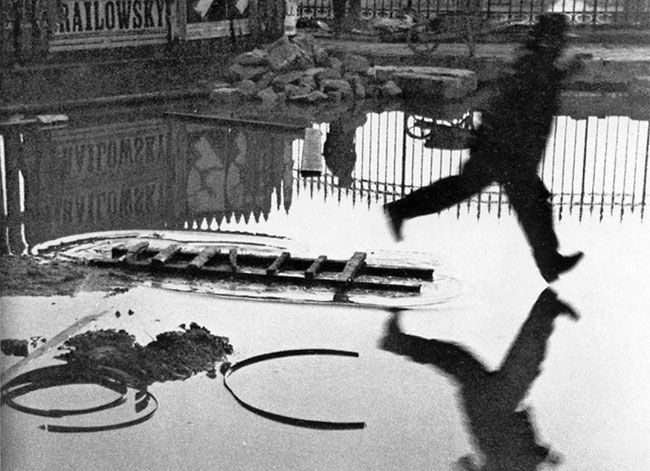 Man Jumping the Puddle by Henri Cartier-Bresson (1930)